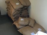bags of sand sitting on top of a bed in a room