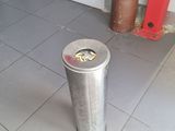 a trash can sitting in the middle of a kitchen floor