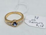 an image of a gold ring with a sapphire stone and diamonds