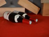 two bottles of wine sitting next to each other on a table