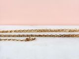 a close up of a gold chain with a heart pendant on it