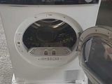 an image of a washing machine sitting on the ground next to a trash can