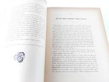 an open book with a picture of a flower on it