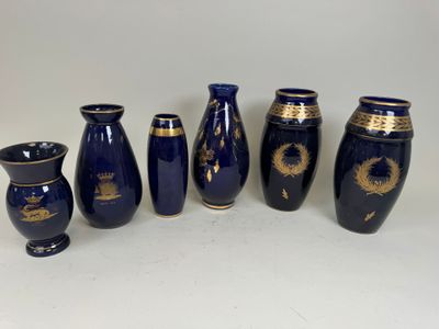 five blue vases with gold designs are lined up against a white background