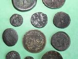 some of the ancient coins are on a green surface