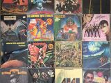 many different album covers on the wall of a room