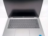 an open laptop computer sitting on top of a white table
