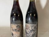 two bottles of wine sitting next to each other on a table