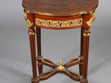 an image of a small table with a wooden top and gold decoration