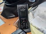 a cell phone sitting on top of a table next to a purse