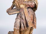 statue of a bearded man with a book and a dog