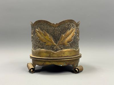 an image of a brass vase with two birds on it