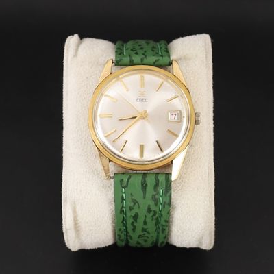 une image représentant une montre-bracelet dorée et verte, dotée d'un bracelet vert