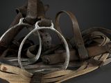 a pile of old leather and metal items on a table