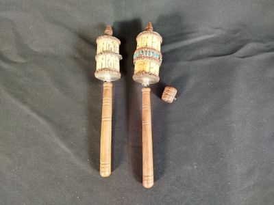 Voici deux maillets en bois posés sur un tissu noir.