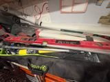 several skis and ski poles are stacked on top of each other