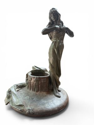statue of a woman holding a bird on a pedestal