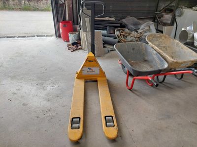 a fork and a wheelbarrow in a garage