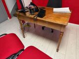 a desk with a phone and a laptop on it