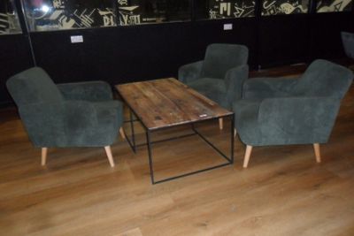 three chairs and a table in the middle of a room