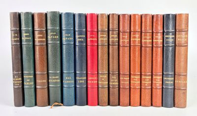 several old books are lined up in a row on a white surface