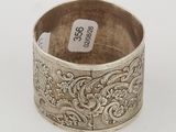a silver ring with a floral design on it