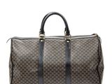 a brown and black duffel bag on a white background