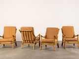 four chairs in a row in a room with a wall in the background