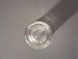 a glass of water sitting on a table with a shadow on it