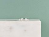 a close up of a white marble box with a diamond ring on top