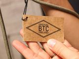 a person holding a brown tag that says original bitc england