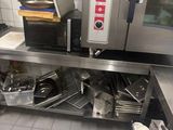 a commercial kitchen with stainless steel counter tops and stainless steel appliances