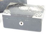 a small black box with a flower design on it