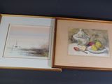 two framed pictures of fruit and a teapot on a table