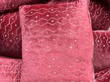 pillows piled on top of each other in a pile