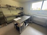 a large kitchen with a stainless steel table and a large window