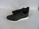black and white running shoes on a white surface