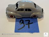 une petite voiture posée sur une feuille de papier bleue