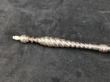 a close up of a metal object on a black surface