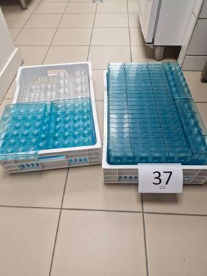 two plastic containers that are sitting on the floor