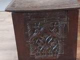 a small wooden table with a carved design on top of it