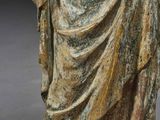 an old statue of a woman holding a baby in her arms