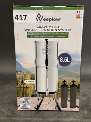 the box of a water filtrator is open on a table