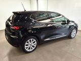 the rear end of a black car in a garage