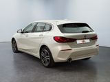 the rear end of a white bmw car parked in a room
