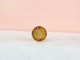 a gold coin sitting on top of a white counter