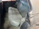 an old car with a leather seat in the back of it