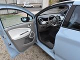 a car with its door open and a trash can in the door