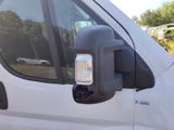a white van that has a light on the side of it