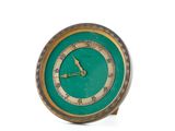 a green clock sitting on top of a white table